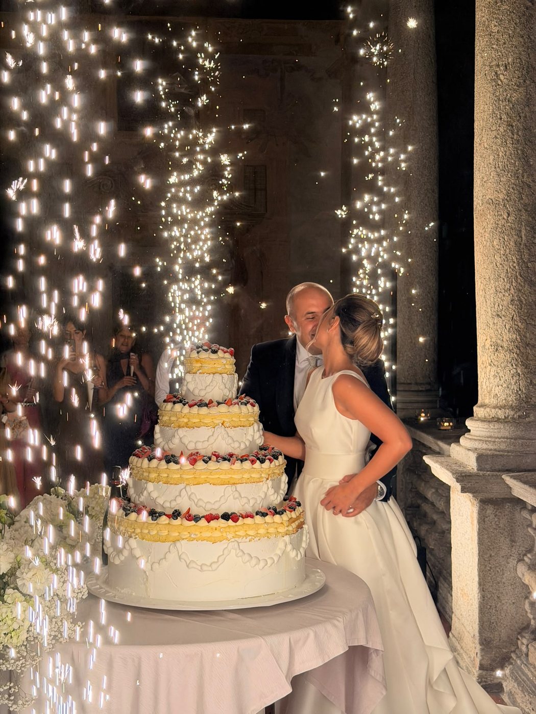 Lucrezia e Giorgio al taglio della torta, sotto una pioggia di scintille